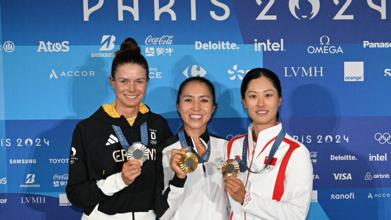 Lydia Ko of Team New Zealand, gold medalist, Esther Henseleit of Team Germany, silver medalist, and Xiyu Lin of team China, bronze medalist, pose together after the final round of the 2024 Paris Olympics at Le Golf National